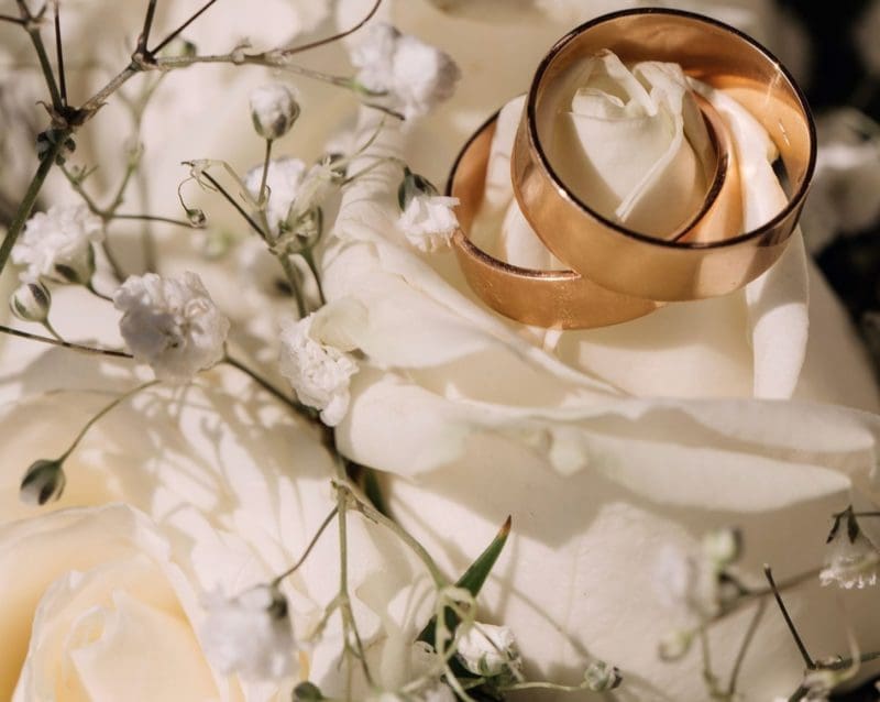 Two Wedding Rings on Fabric and Flowers